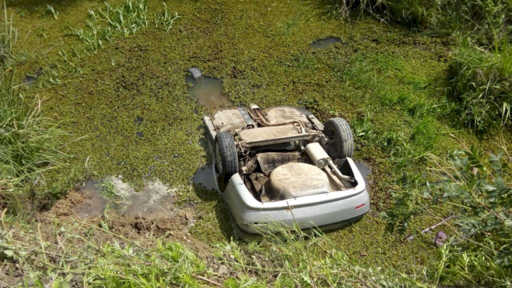 Carro cai dentro de córrego e motorista sai ileso