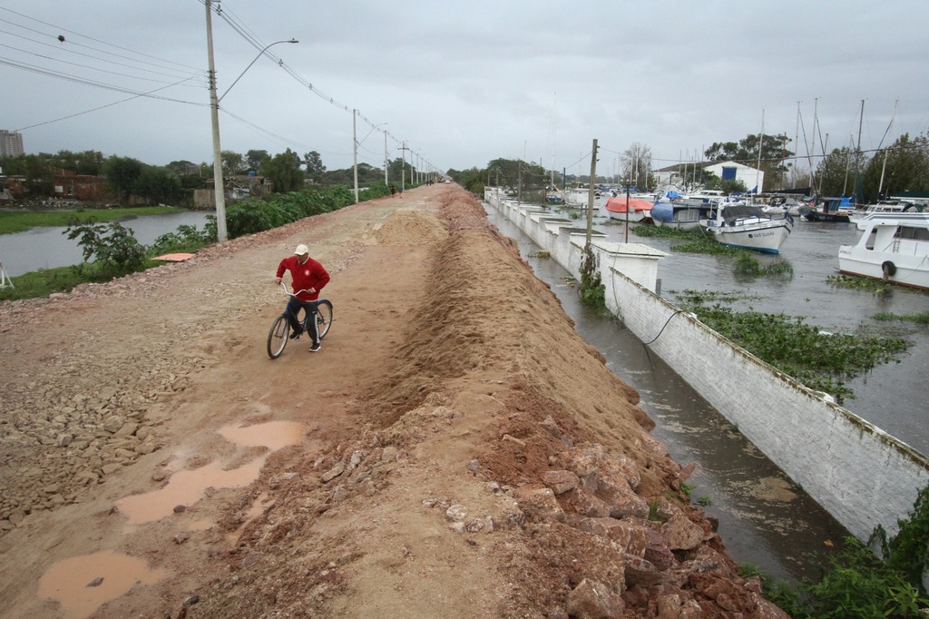 Foto: Jô Folha - Na Estrada do Engenho, construção de diques improvisados para conter o São Gonçalo é o contraste com a movimentação rotineira de moradores